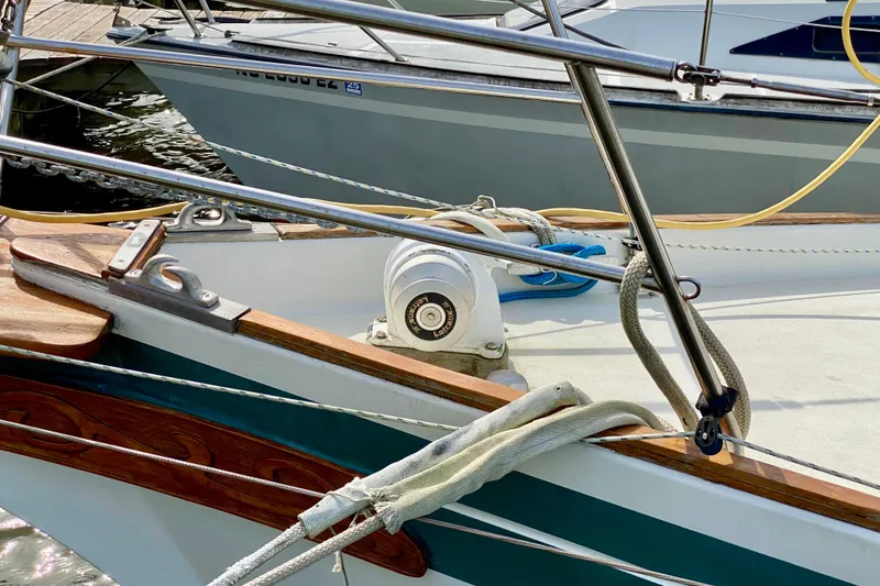 Slide: The Image of 1986 Bayfield 32 sailboat deck with winch and ropes in marina. - 17