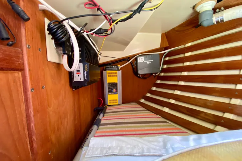 Slide: The Image of 1986 Bayfield 32 interior with electrical equipment and wooden paneling. - 34
