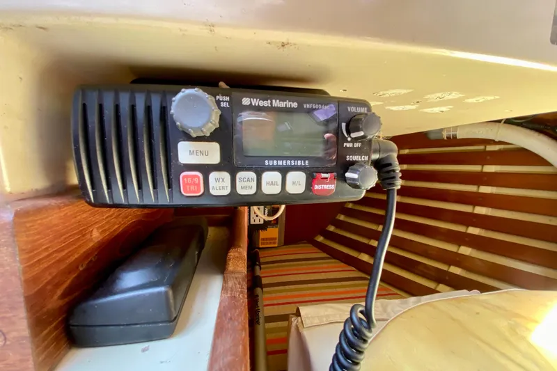 Slide: The Image of VHF radio on 1986 Bayfield 32 sailboat interior, featuring West Marine model. - 35