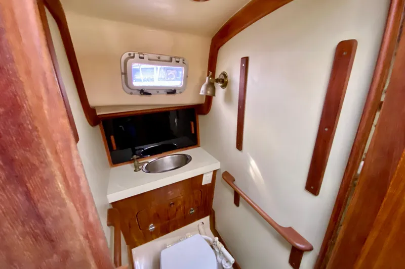 Slide: The Image of Interior of 1986 Bayfield 32 sailboat bathroom with sink and wooden accents. - 36
