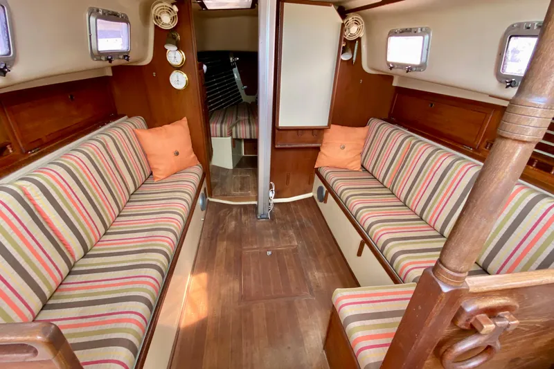 Slide: The Image of 1986 Bayfield 32 sailboat interior with striped cushions and wooden accents. - 45