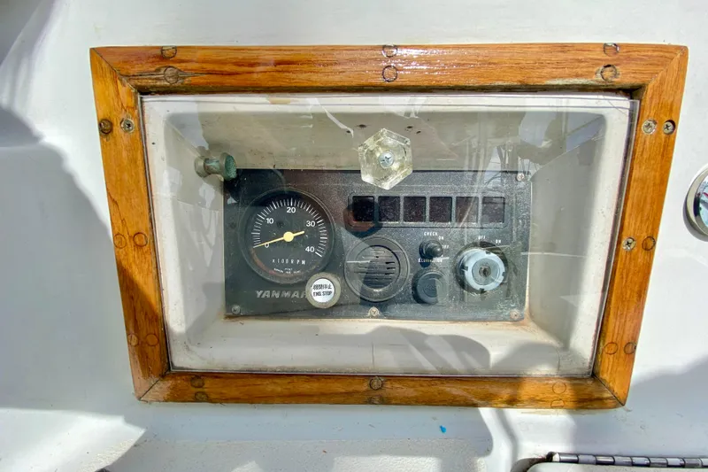 Slide: The Image of Control panel of a 1986 Bayfield 32 sailboat with wooden frame and Yanmar gauge. - 9