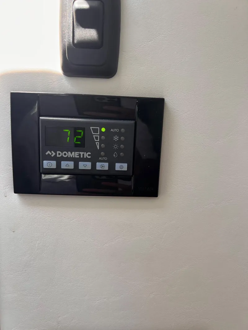 Slide: The Image of Dometic thermostat displaying 72 degrees on a 2019 Cruisers Yachts 338 IO. - 34