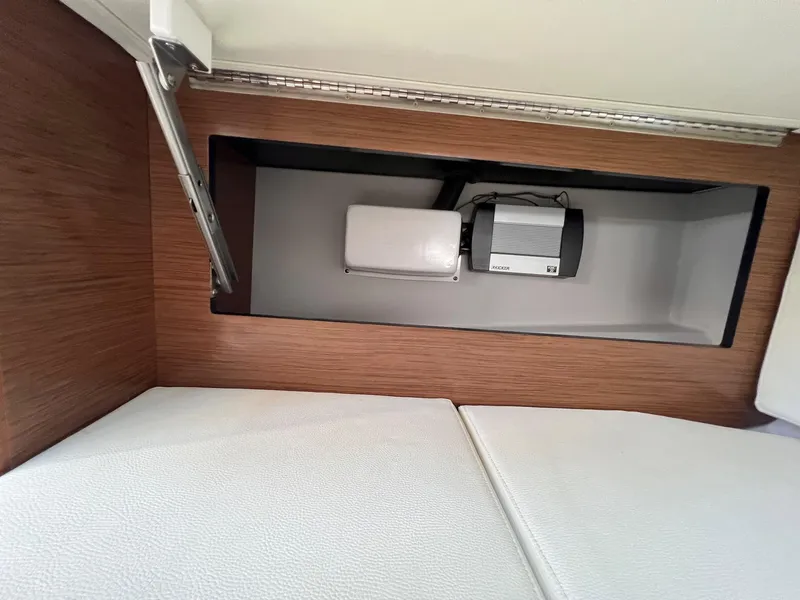 Slide: The Image of Interior storage compartment in 2019 Cruisers Yachts 338 IO, featuring sleek wood finish and modern design. - 38