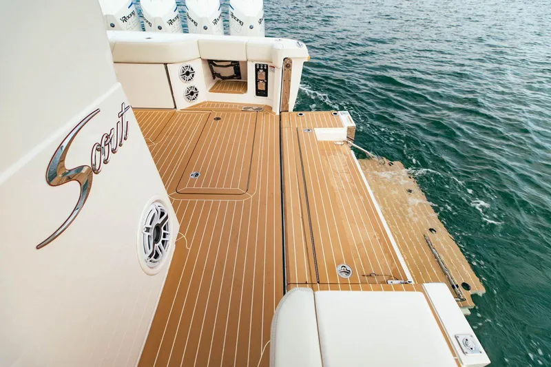 Slide: The Image of 2021 Scout 530 LXF boat deck with teak flooring, near water. - 10