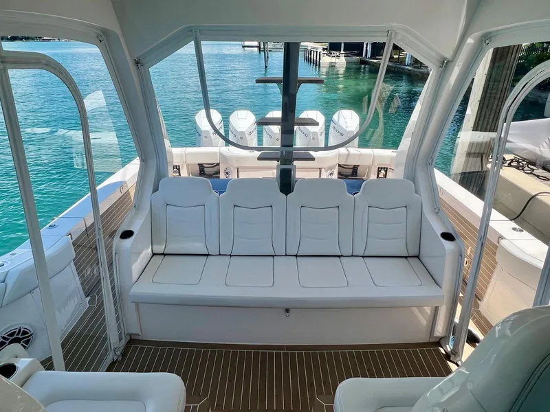 Slide: The Image of 2021 Scout 530 LXF boat interior with white seating and clear ocean view. - 11