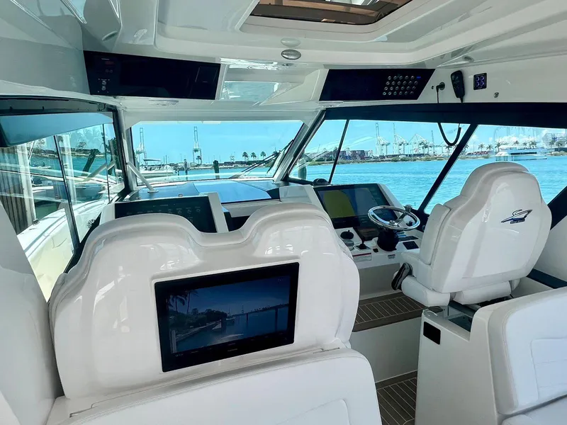 Slide: The Image of Interior view of 2021 Scout 530 LXF yacht cockpit with modern controls and seating. - 12