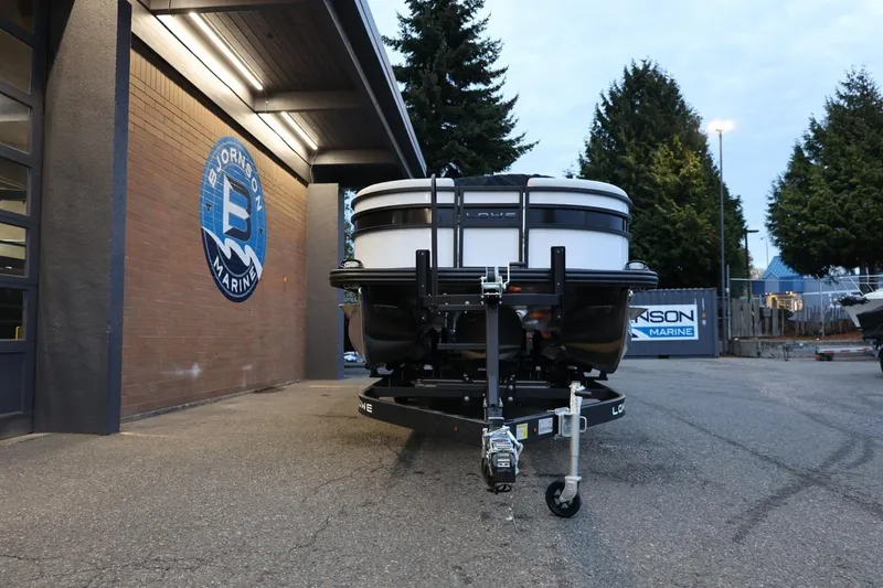 Slide: The Image of 2026 Lowe SS 230 CL boat on trailer outside marine dealership. - 12