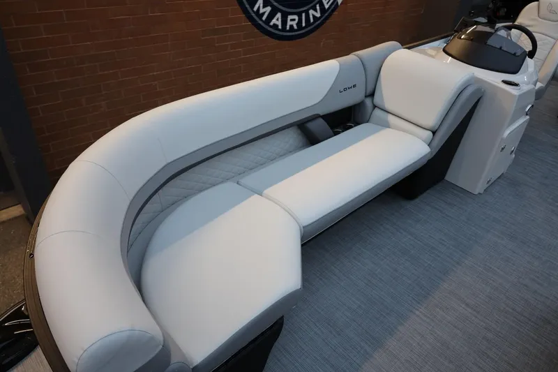 Slide: The Image of 2026 Lowe SS 230 CL boat interior with sleek, modern seating and steering console. - 16