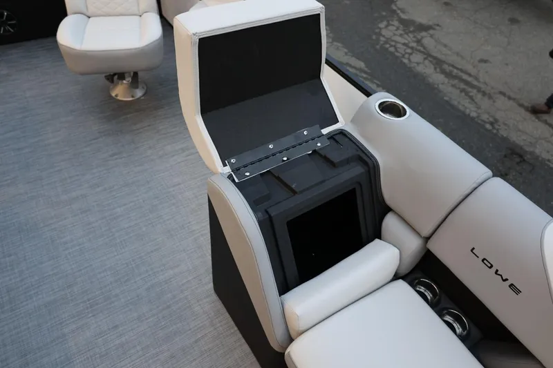 Slide: The Image of 2026 Lowe SS 230 CL boat interior with open storage compartment and cushioned seating. - 20