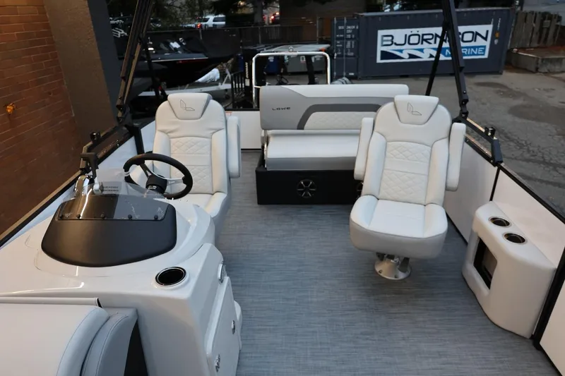 Slide: The Image of 2026 Lowe SS 230 CL boat interior with white seating and steering console. - 21