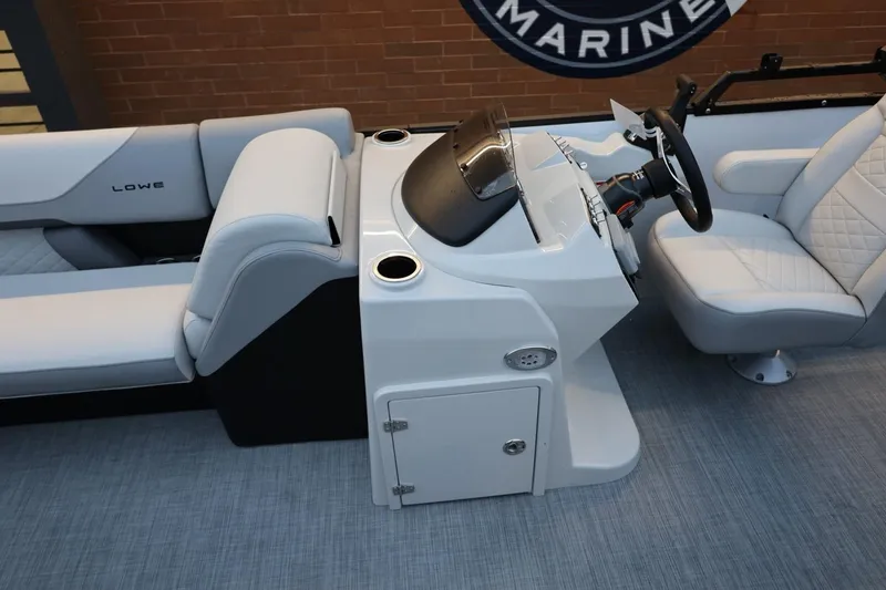 Slide: The Image of 2026 Lowe SS 230 CL boat interior with modern helm and comfortable seating. - 22