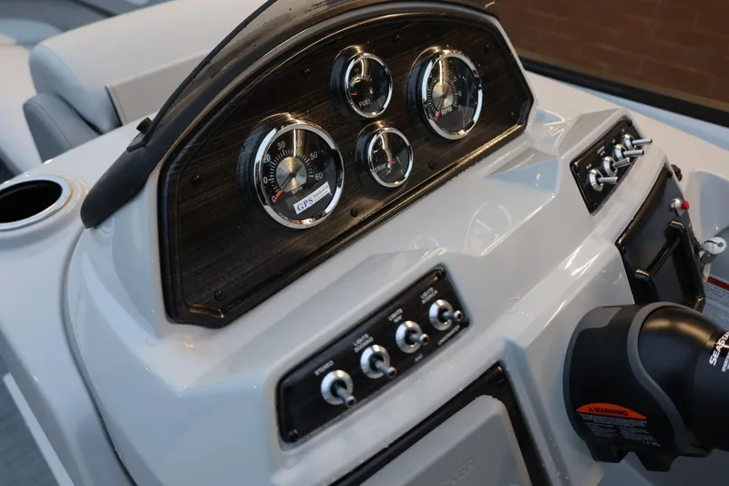 Slide: The Image of 2026 Lowe SS 230 CL boat dashboard with gauges and controls. - 25