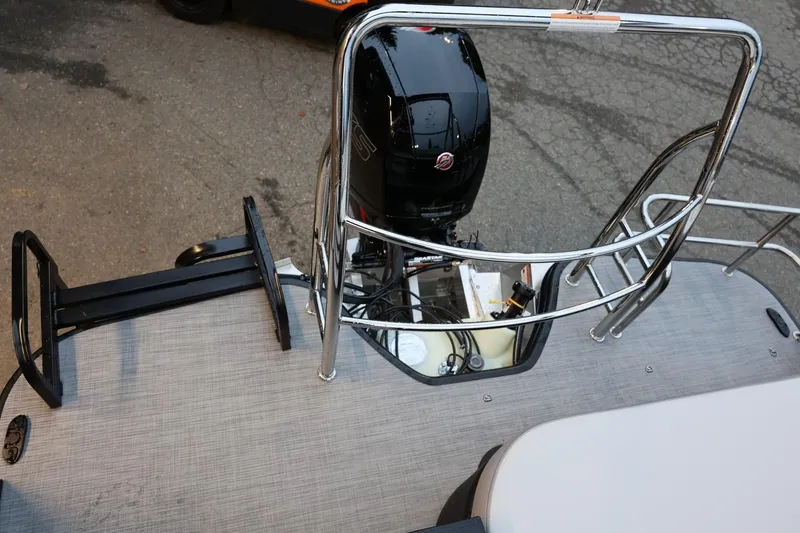 Slide: The Image of 2026 Lowe SS 230 CL boat with outboard motor and safety railing. - 31