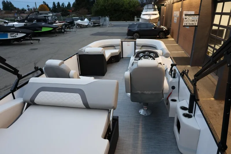 Slide: The Image of 2026 Lowe SS 230 CL pontoon boat interior with modern seating and steering console. - 32