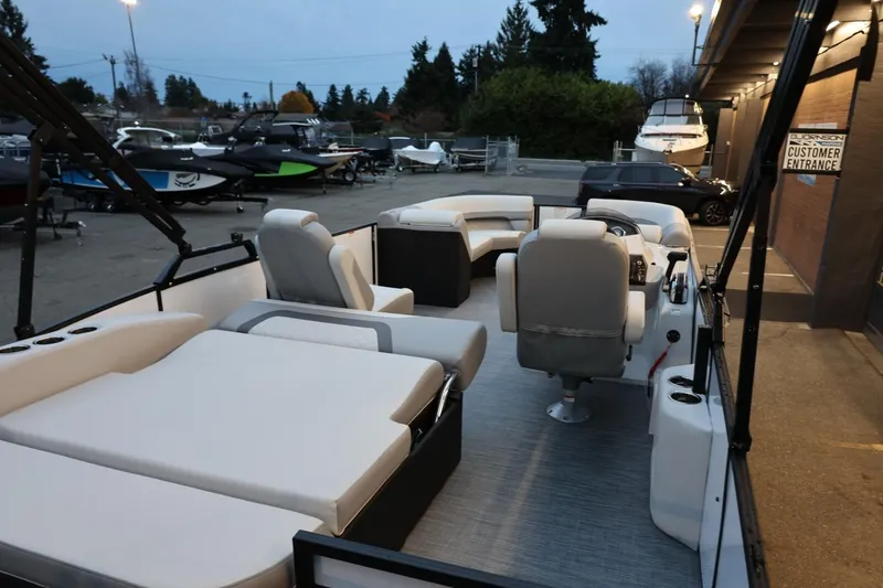 Slide: The Image of 2026 Lowe SS 230 CL pontoon boat with spacious seating and modern design in a marina setting. - 35