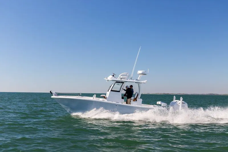 The Image of 2024 Freeman 28 boat cruising on open water under clear blue sky. - 0