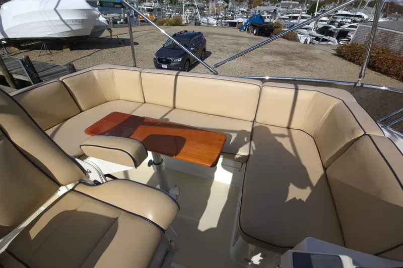 Slide: The Image of 2017 Sabre 48 Fly Bridge helm with Garmin navigation and wooden steering wheel. - 18
