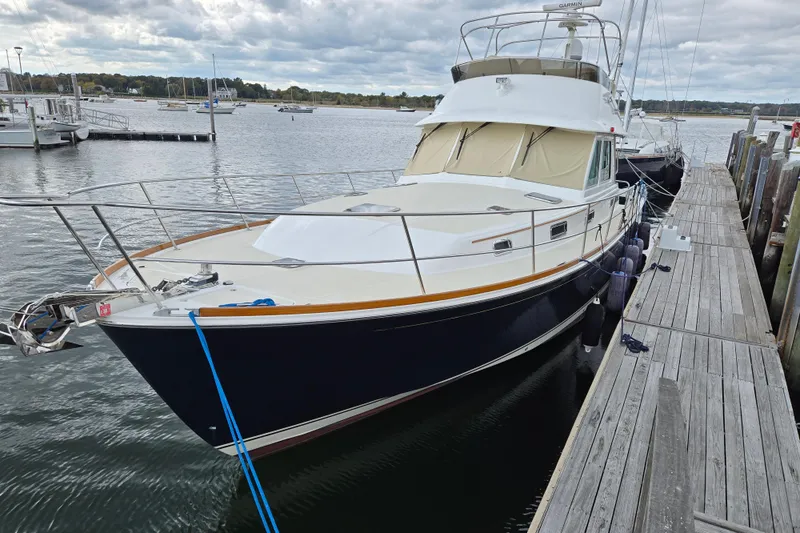 Slide: The Image of 2017 Sabre 48 Fly Bridge helm with Garmin navigation system and wooden steering wheel. - 2