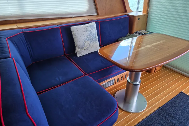 Slide: The Image of Interior of 2017 Sabre 48 Fly Bridge with blue seating and TV. - 27