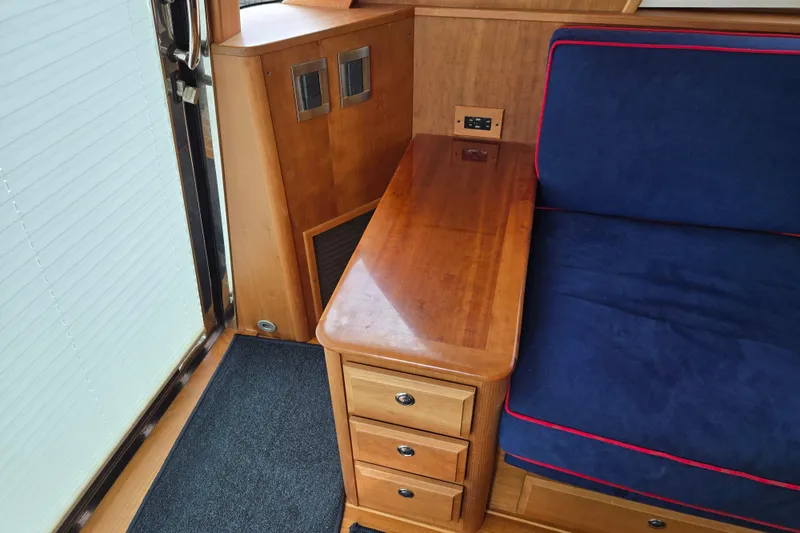 Slide: The Image of Luxurious interior of 2017 Sabre 48 Fly Bridge with blue seating and wooden table. - 30