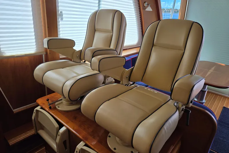 Slide: The Image of 2017 Sabre 48 Fly Bridge helm with Garmin navigation and wooden steering wheel. - 39