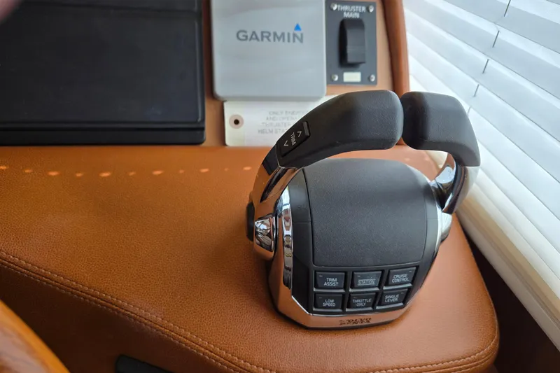 Slide: The Image of Steering wheel of 2017 Sabre 48 Fly Bridge yacht, featuring wood and chrome design. - 40