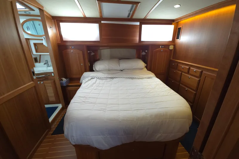 Slide: The Image of Luxurious 2017 Sabre 48 Fly Bridge yacht kitchen with wood cabinetry and modern appliances. - 58