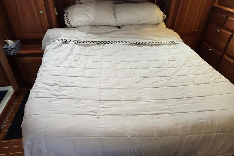 Slide: The Image of Cozy bedroom interior of 2017 Sabre 48 Fly Bridge yacht with wooden cabinetry. - 60