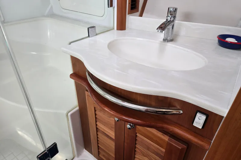 Slide: The Image of Wooden cabinetry in 2017 Sabre 48 Fly Bridge yacht interior, featuring drawers and doors. - 62
