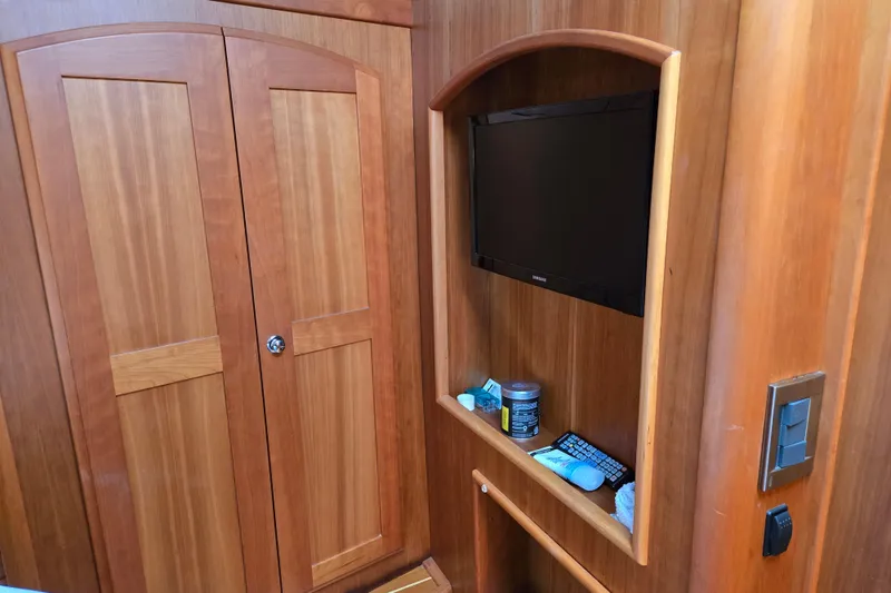 Slide: The Image of Cozy bedroom in 2017 Sabre 48 Fly Bridge yacht with wooden cabinetry and plush bedding. - 66