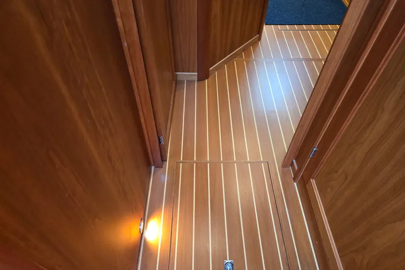 Slide: The Image of Cozy bedroom in 2017 Sabre 48 Fly Bridge yacht with wooden paneling and plaid blanket. - 67