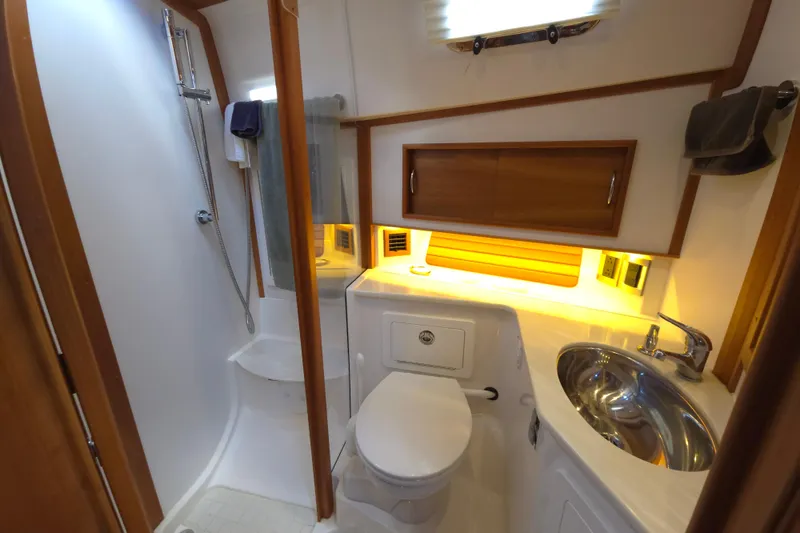 Slide: The Image of Interior of 2017 Sabre 48 Fly Bridge with wooden cabinetry and built-in TV. - 68