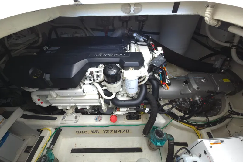 Slide: The Image of 2017 Sabre 48 Fly Bridge yacht bathroom with shower, sink, and wooden cabinetry. - 71