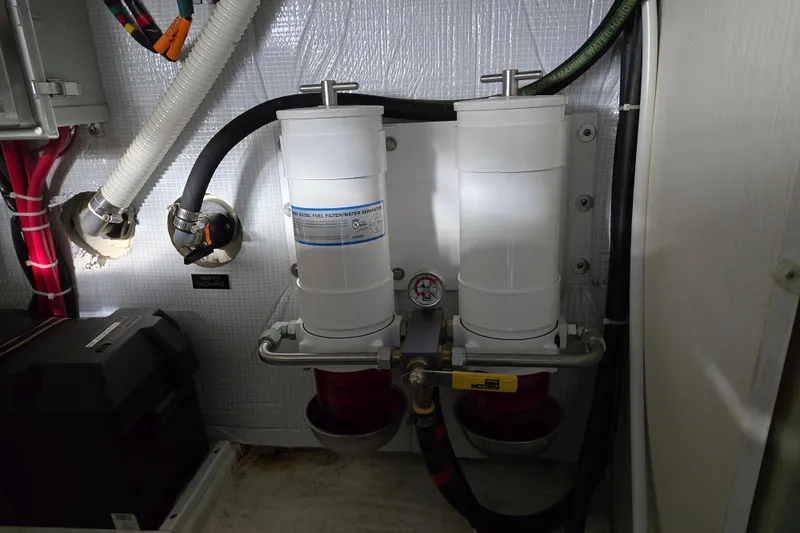 Slide: The Image of Engine room of 2017 Sabre 48 Fly Bridge with visible hoses and wiring. - 78