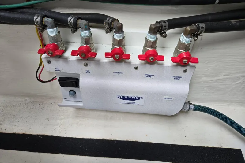 Slide: The Image of Engine compartment of 2017 Sabre 48 Fly Bridge with marine hoses and fittings. - 79