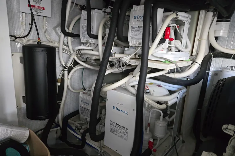 Slide: The Image of Engine room of 2017 Sabre 48 Fly Bridge with Dometic systems and complex piping. - 80