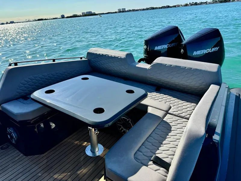 Slide: The Image of Luxury Skipper-BSK 34 boat interior with seating and table, 2025 model, on serene water. - 24