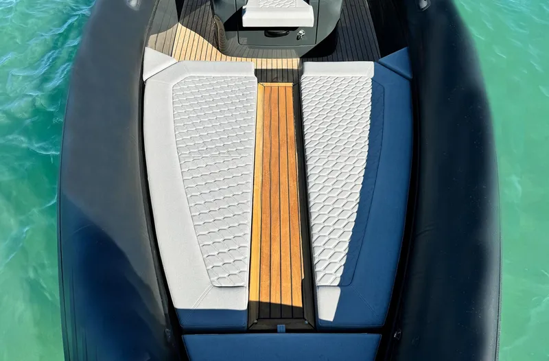 Slide: The Image of Skipper-BSK 34 boat interior, 2025 model, featuring sleek seating and wooden deck. - 8