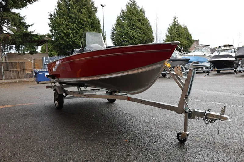 Slide: The Image of 2026 Lund 1400 Fury SS boat on trailer in outdoor setting. - 11