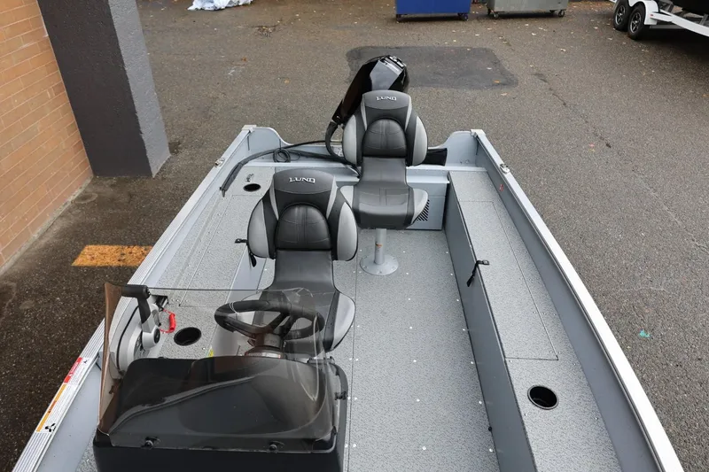 Slide: The Image of 2026 Lund 1400 Fury SS boat interior with steering console and seating. - 18