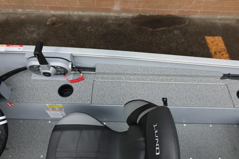 Slide: The Image of 2026 Lund 1400 Fury SS boat interior with steering controls and seating. - 20