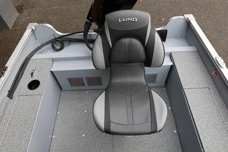 Slide: The Image of 2026 Lund 1400 Fury SS boat seat, gray and black design, on textured flooring. - 21