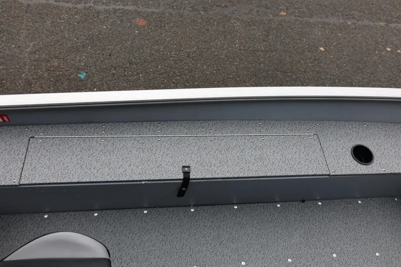 Slide: The Image of 2026 Lund 1400 Fury SS boat interior with storage compartment and seating. - 22