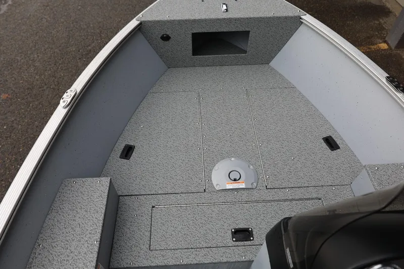 Slide: The Image of 2026 Lund 1400 Fury SS boat interior with gray textured flooring. - 23