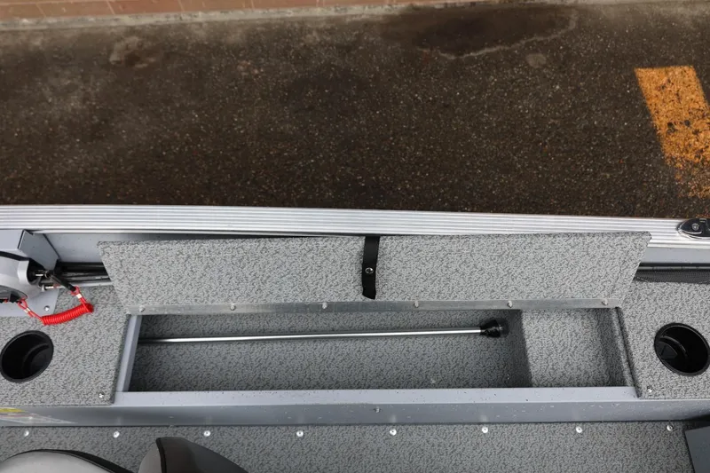 Slide: The Image of 2026 Lund 1400 Fury SS boat interior with storage compartment and cup holders. - 24