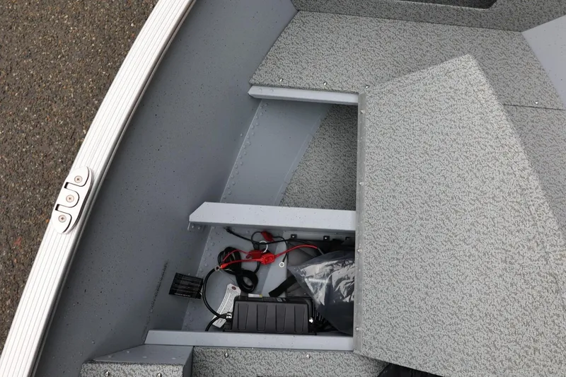 Slide: The Image of Interior view of 2026 Lund 1400 Fury SS boat storage compartment with wiring. - 28