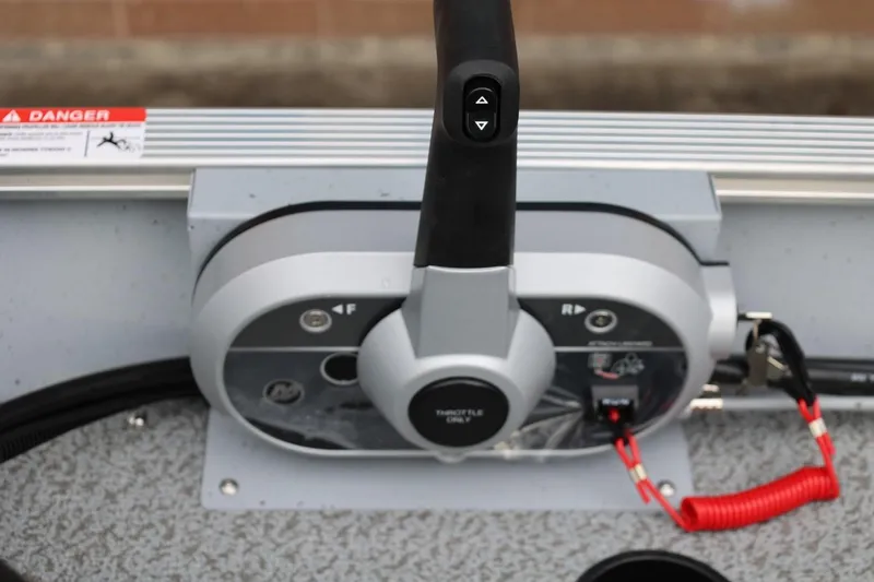Slide: The Image of Control panel of 2026 Lund 1400 Fury SS boat with throttle and safety features. - 31