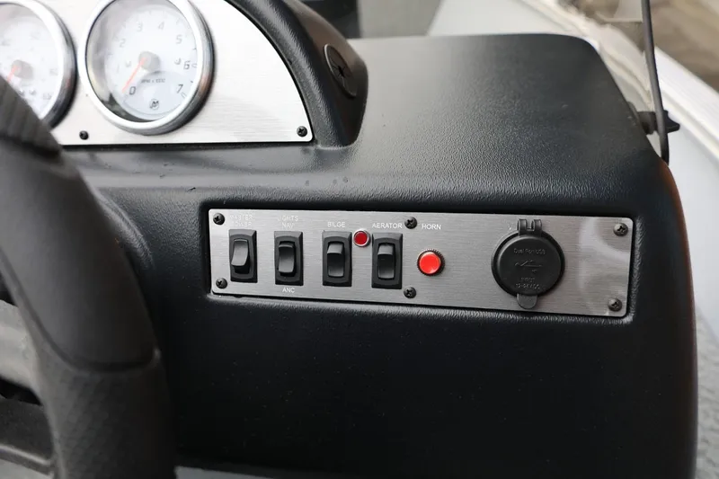 Slide: The Image of Control panel of 2026 Lund 1400 Fury SS boat with switches and gauges. - 32