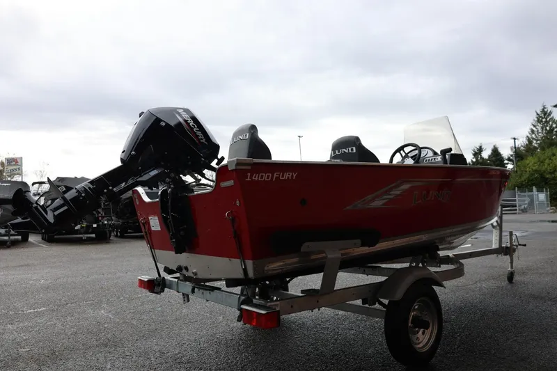 Slide: The Image of 2026 Lund 1400 Fury SS boat on trailer, featuring Mercury outboard motor. - 9
